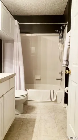 a bedroom with a bed and a television