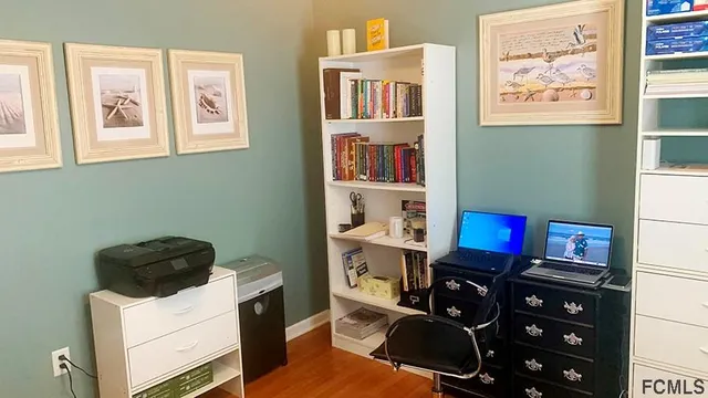 a bedroom with a bed and painting on the wall