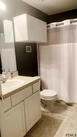 a bedroom with a dresser and mirror