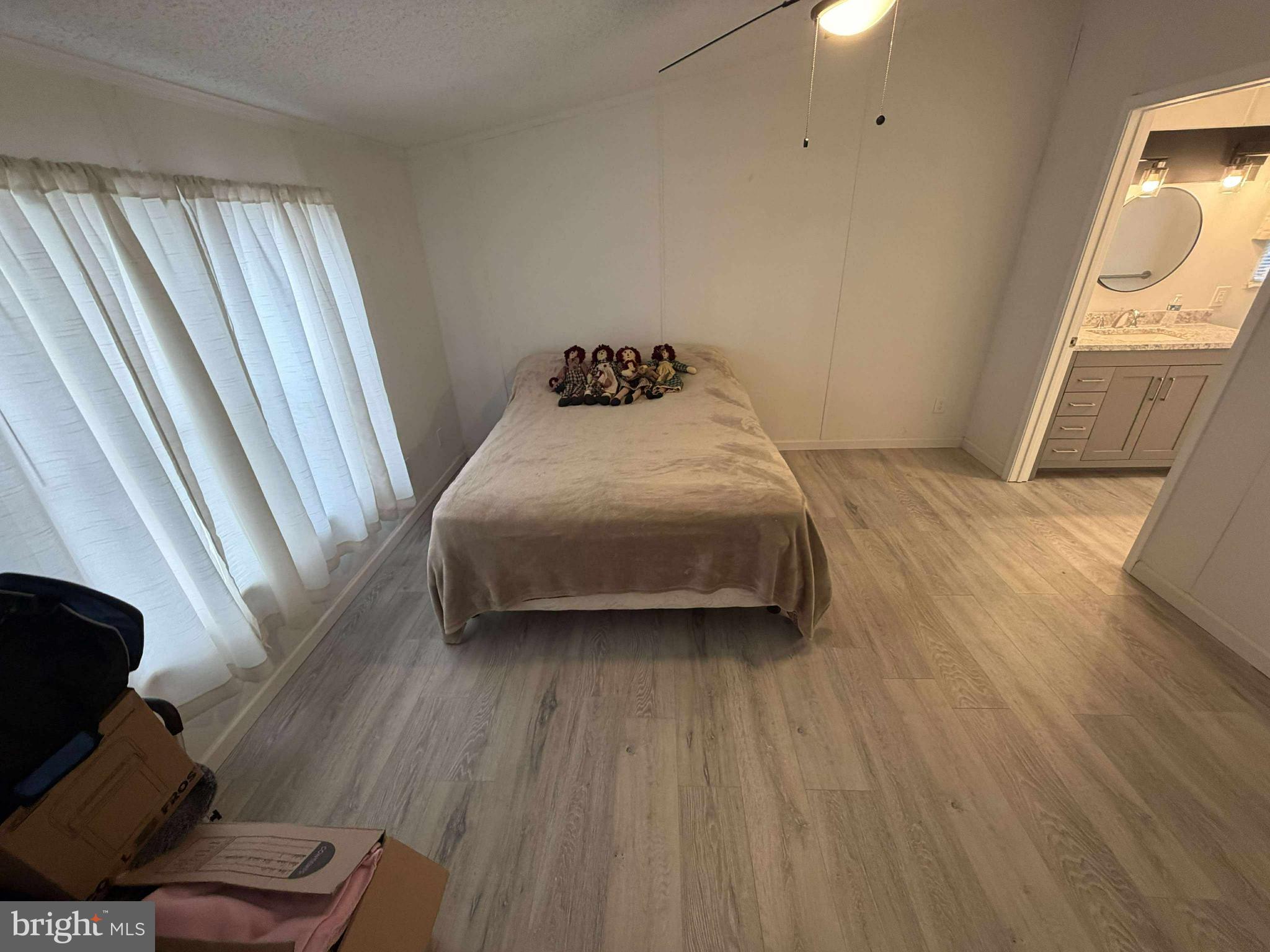 227 Forest Green Road Aberdeen, MD 21001 - Photo 11 of 22 a bedroom with a bed and wooden floor