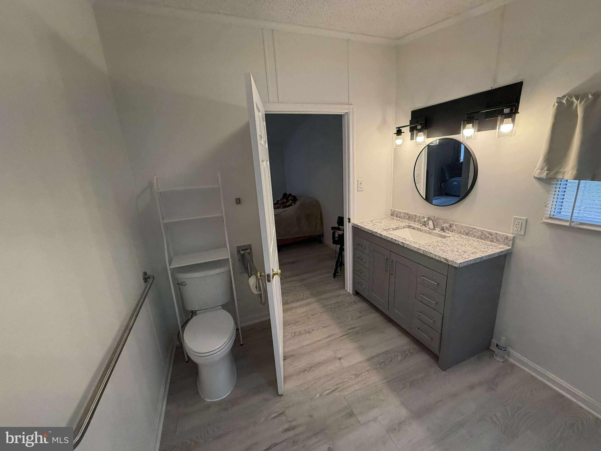 227 Forest Green Road Aberdeen, MD 21001 - Photo 19 of 22 a bathroom with a toilet sink and mirror
