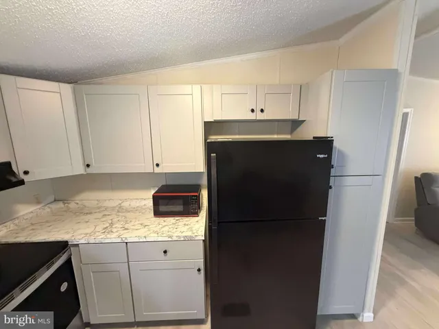 a kitchen with a sink and refrigerator