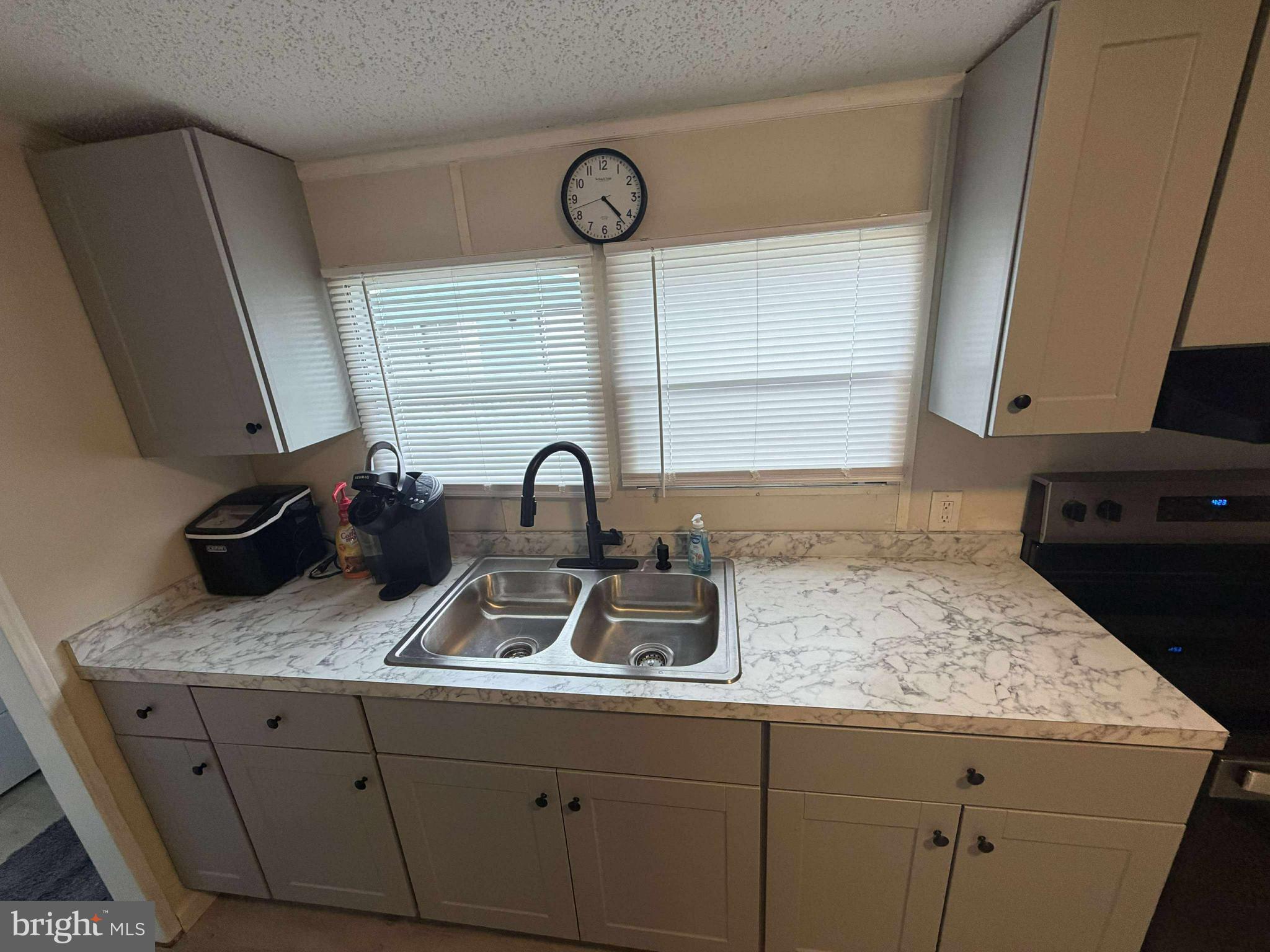 227 Forest Green Road Aberdeen, MD 21001 - Photo 4 of 22 a kitchen with granite countertop a sink a stove and cabinets
