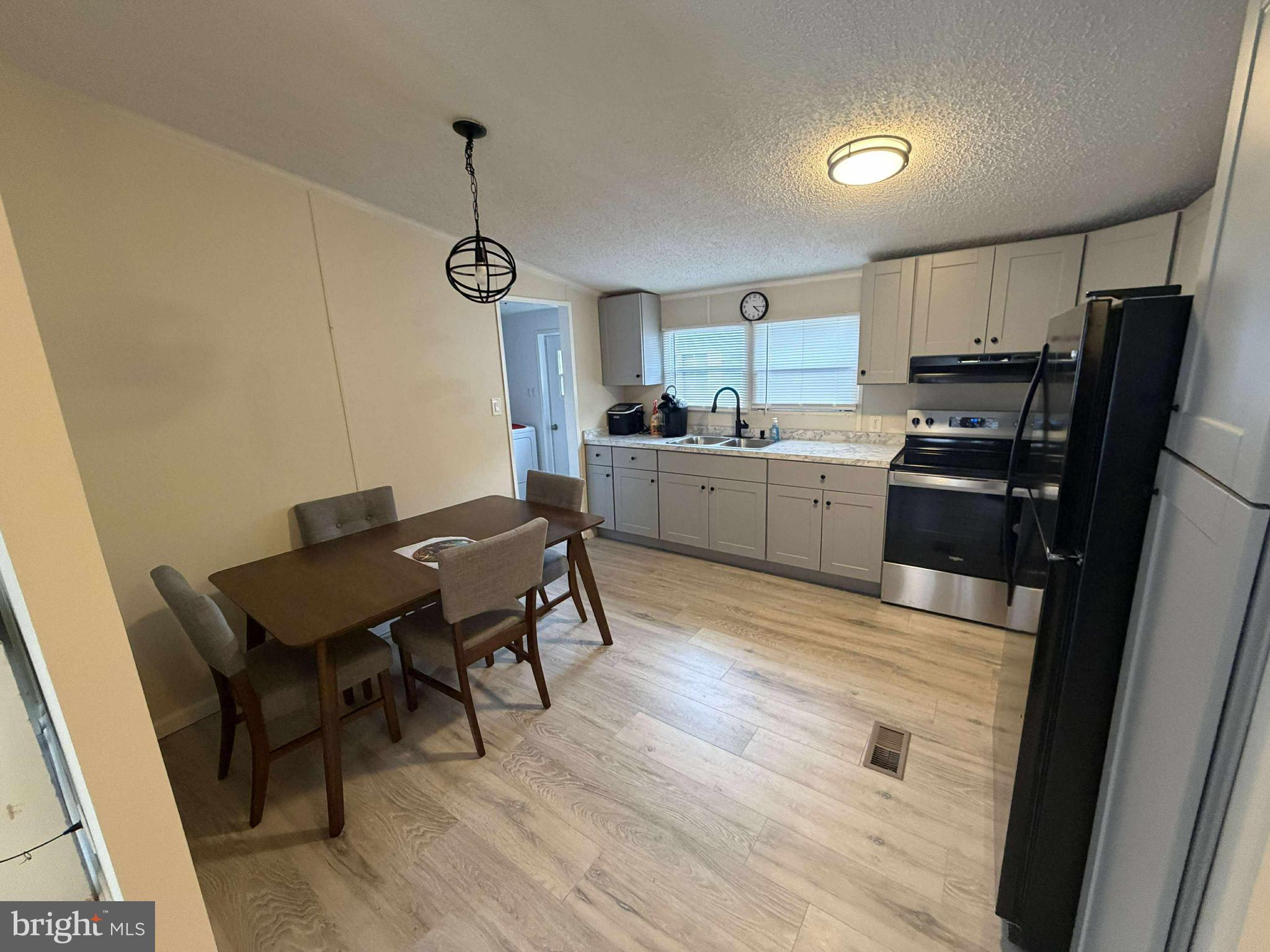 227 Forest Green Road Aberdeen, MD 21001 - Photo 5 of 22 a kitchen with a wooden floor and chairs