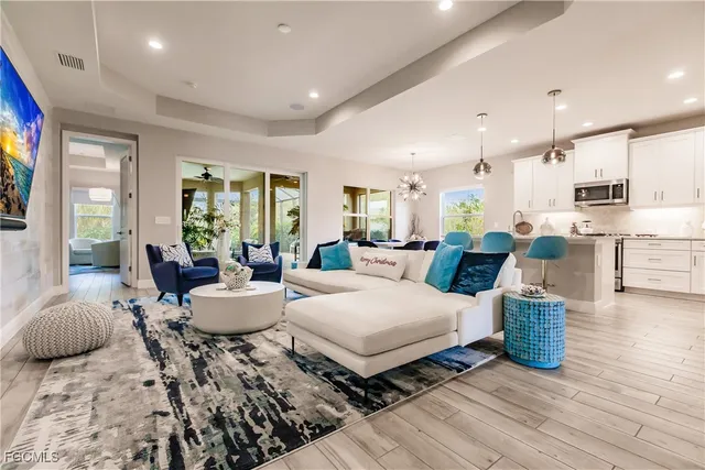 a living room with furniture and wooden floor