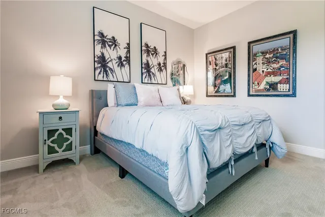 a large bed sitting in a bedroom next to a window