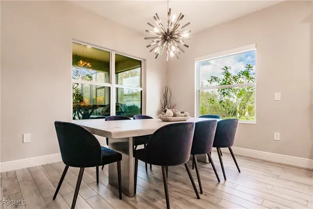 a view of a dining room with furniture and a chandelier