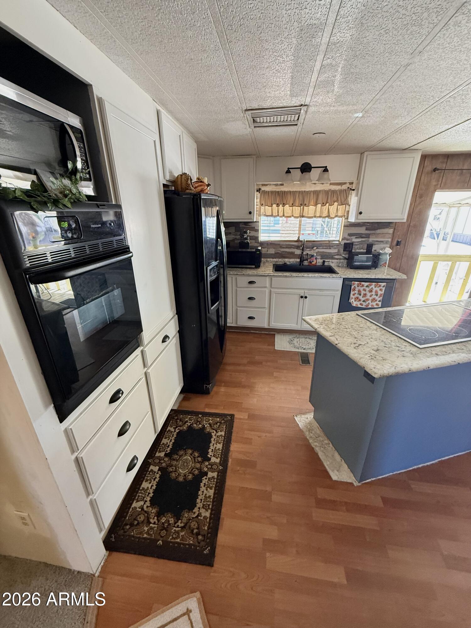 9501 East Broadway Road, Unit 252 Mesa, AZ 85208 - Photo 14 of 31 a kitchen with stainless steel appliances granite countertop a refrigerator a stove and a sink