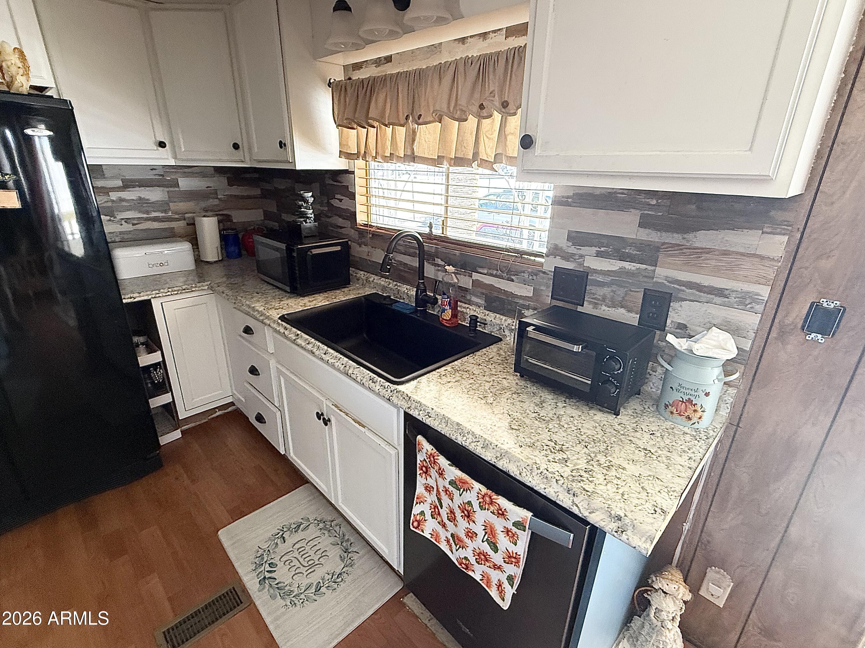 9501 East Broadway Road, Unit 252 Mesa, AZ 85208 - Photo 17 of 31 a kitchen with a stove a sink and a window