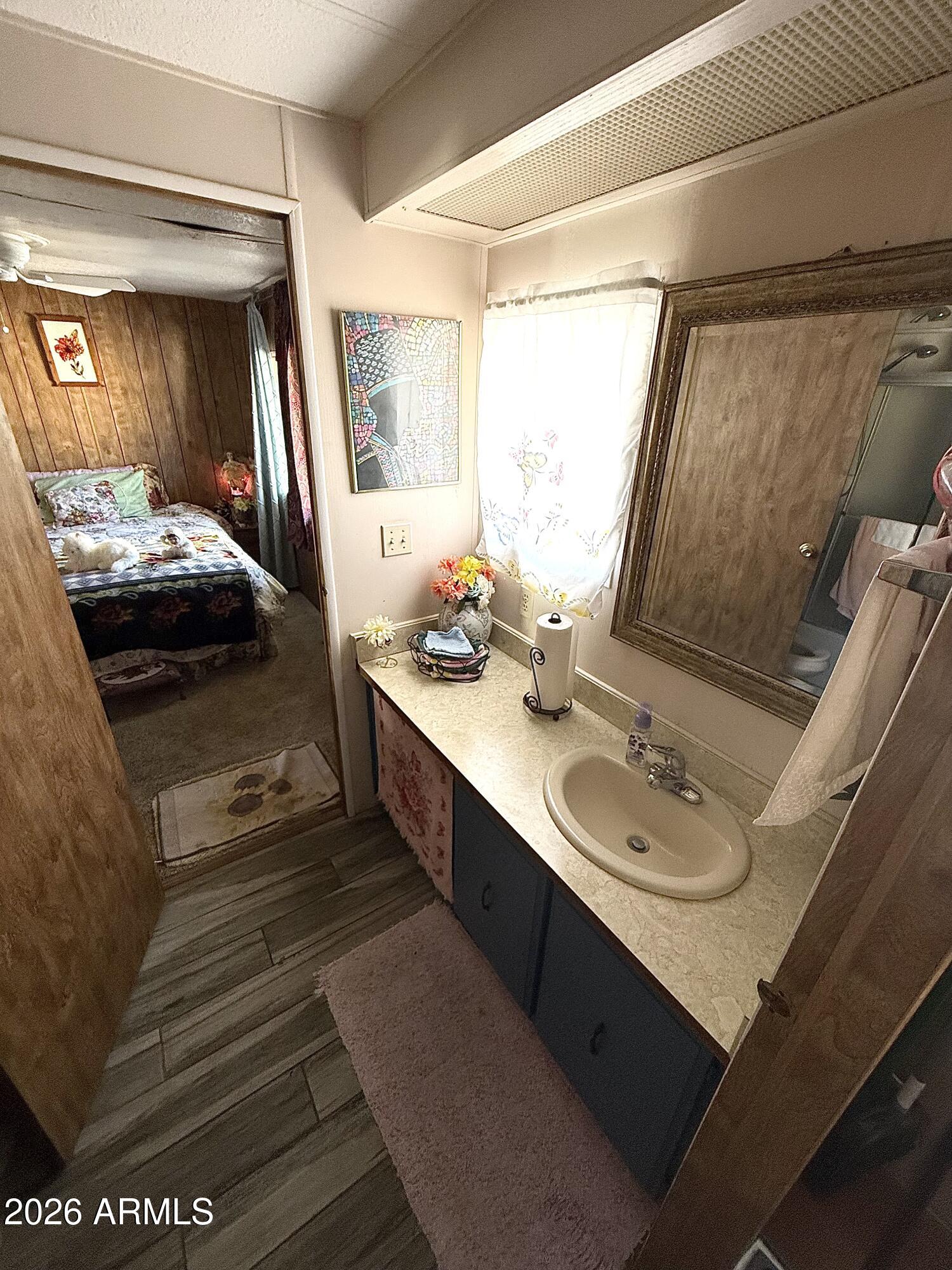9501 East Broadway Road, Unit 252 Mesa, AZ 85208 - Photo 20 of 31 a en suite bathroom with a double vanity sink and a mirror