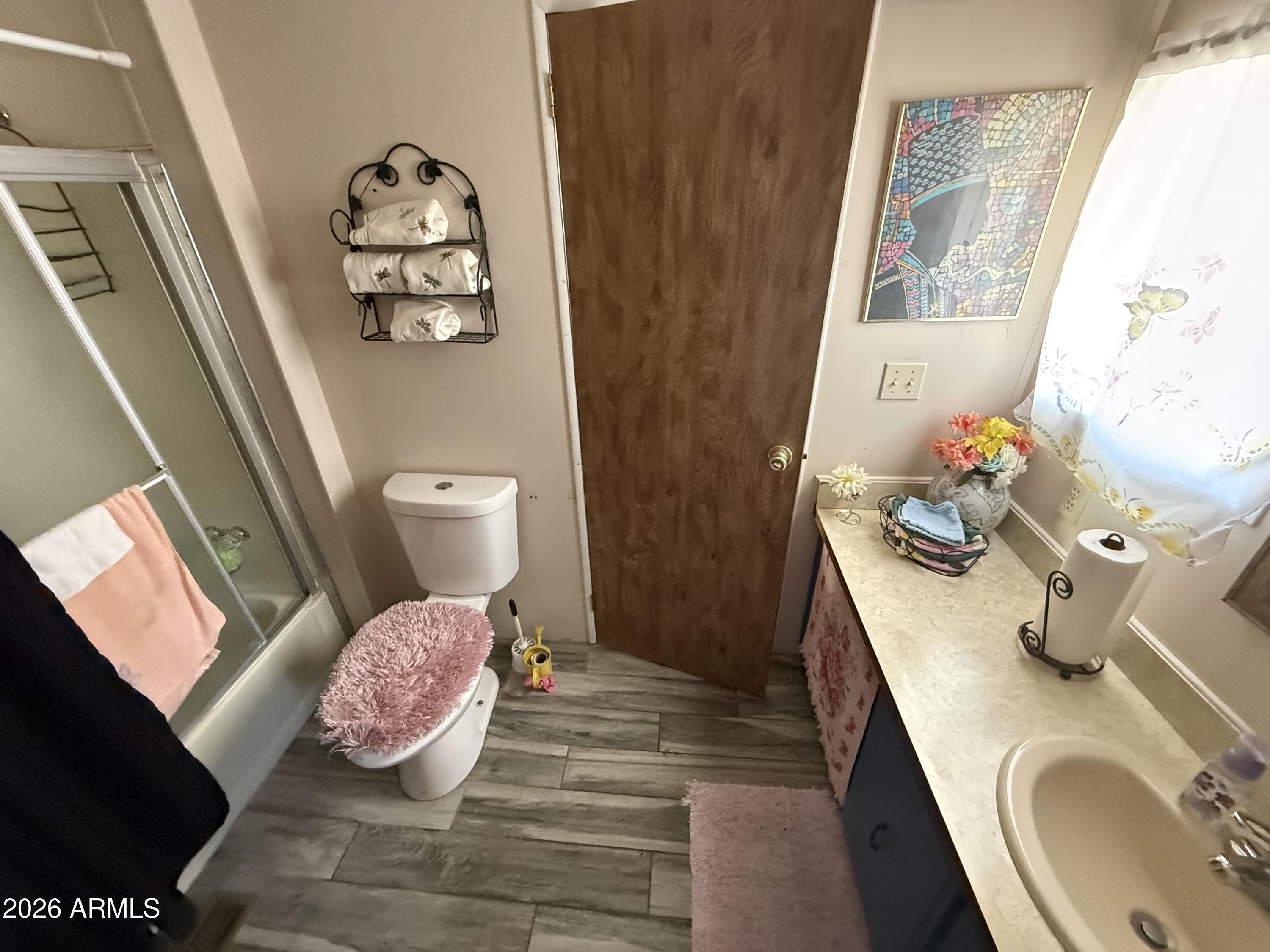 9501 East Broadway Road, Unit 252 Mesa, AZ 85208 - Photo 22 of 31 a bathroom with a sink mirror vanity and toilet