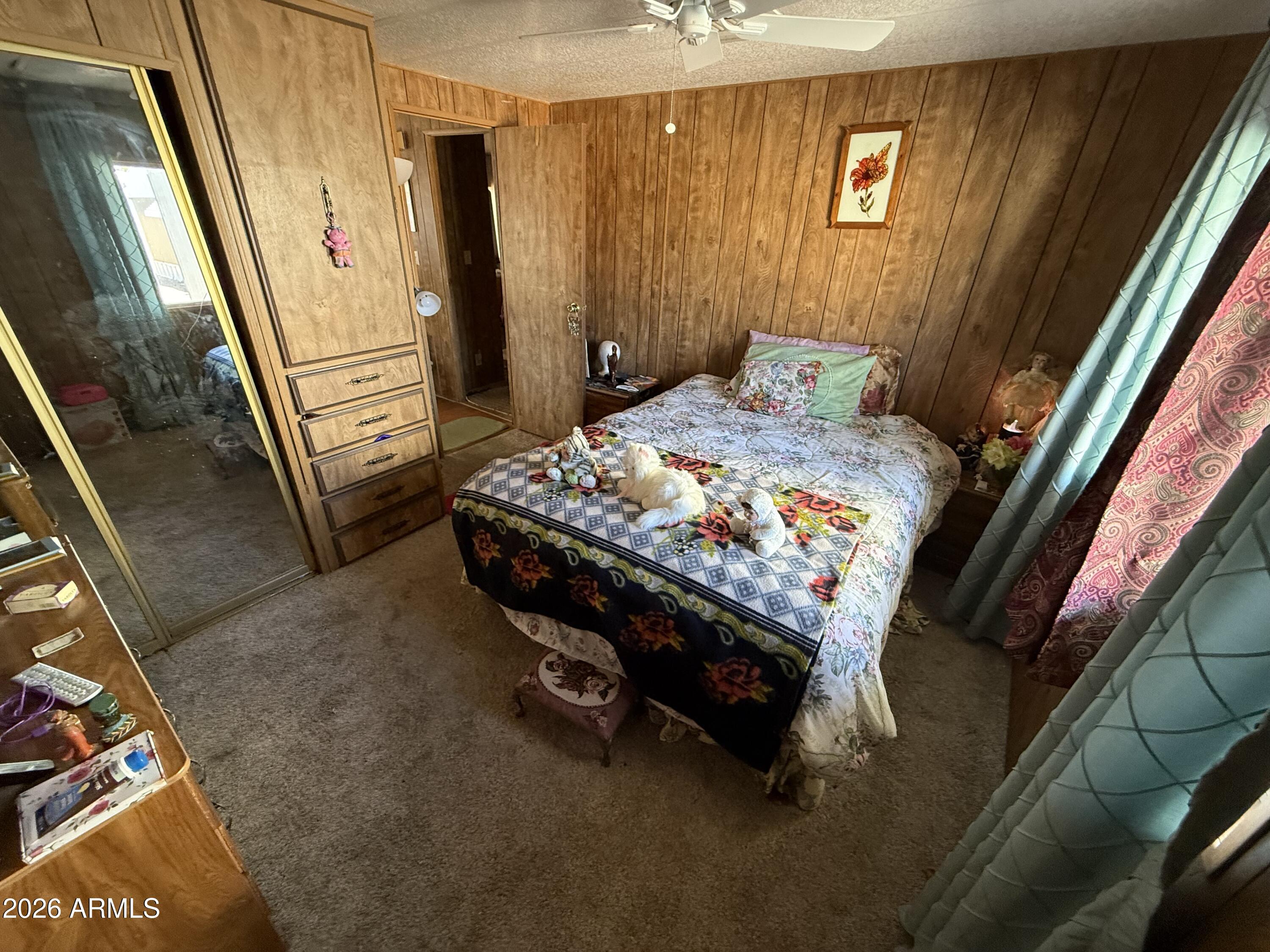 9501 East Broadway Road, Unit 252 Mesa, AZ 85208 - Photo 24 of 31 a bed sitting in a bedroom next to a window