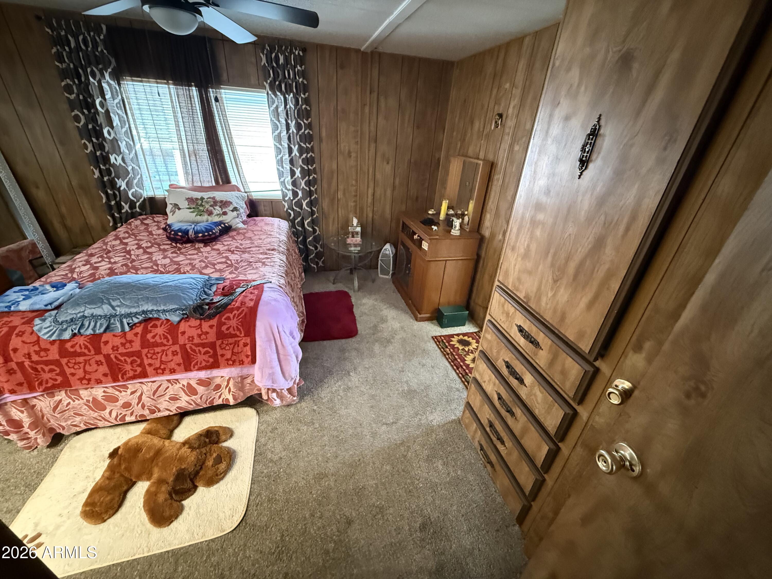 9501 East Broadway Road, Unit 252 Mesa, AZ 85208 - Photo 26 of 31 a bed sitting in a bedroom next to a window