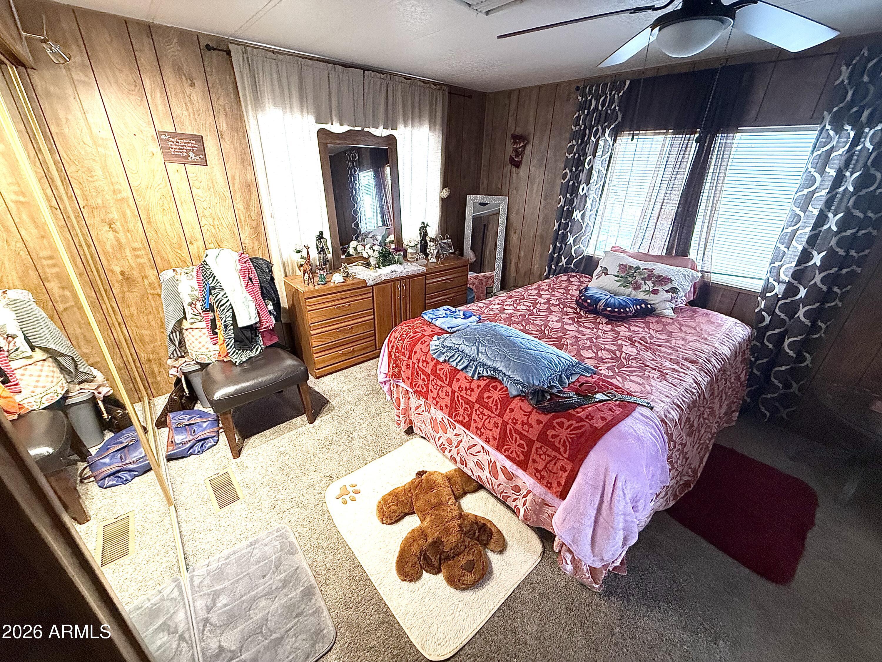 9501 East Broadway Road, Unit 252 Mesa, AZ 85208 - Photo 27 of 31 a bedroom with a bed lamp and a large window