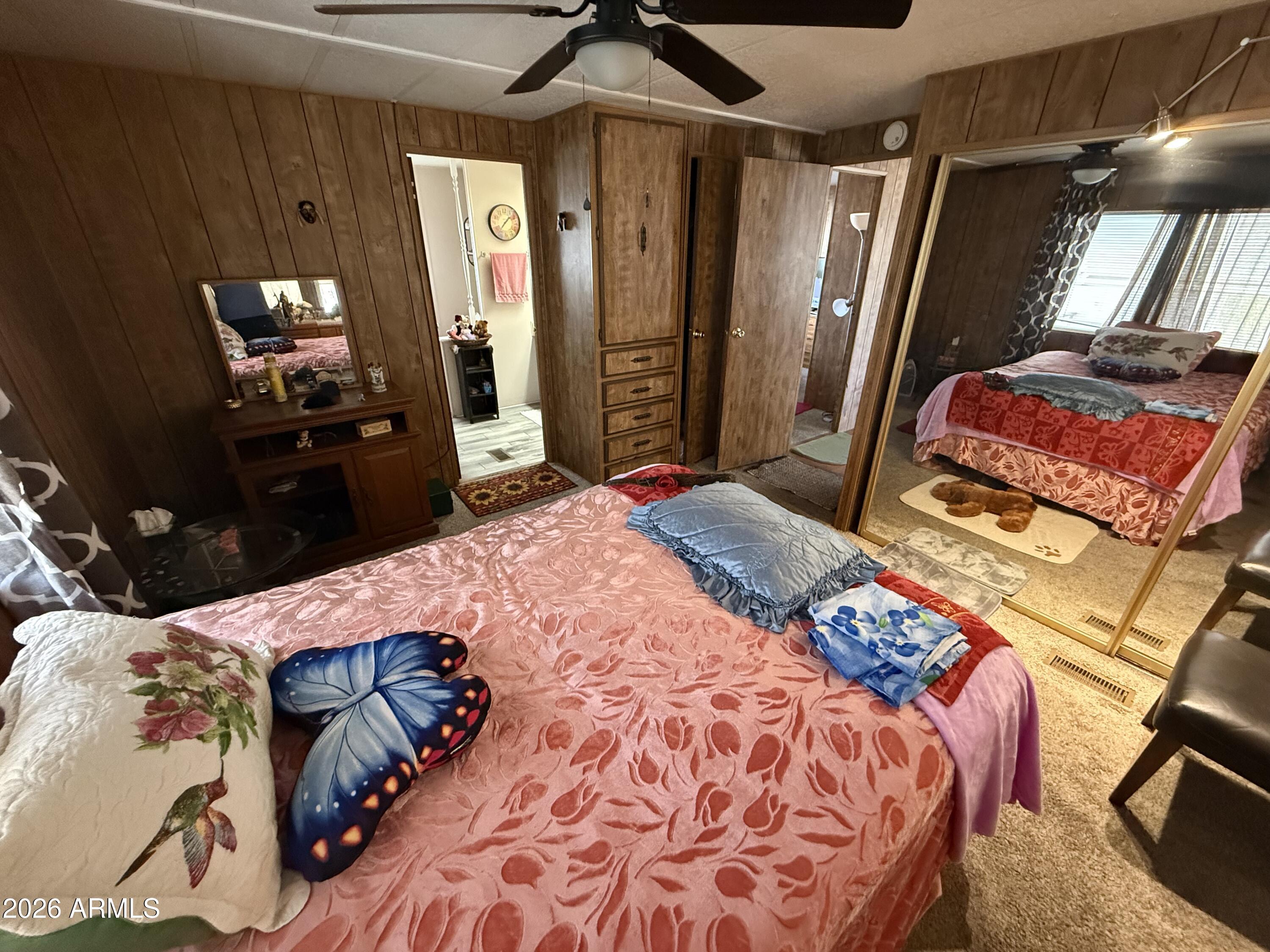 9501 East Broadway Road, Unit 252 Mesa, AZ 85208 - Photo 29 of 31 a bedroom with a bed and a mirror