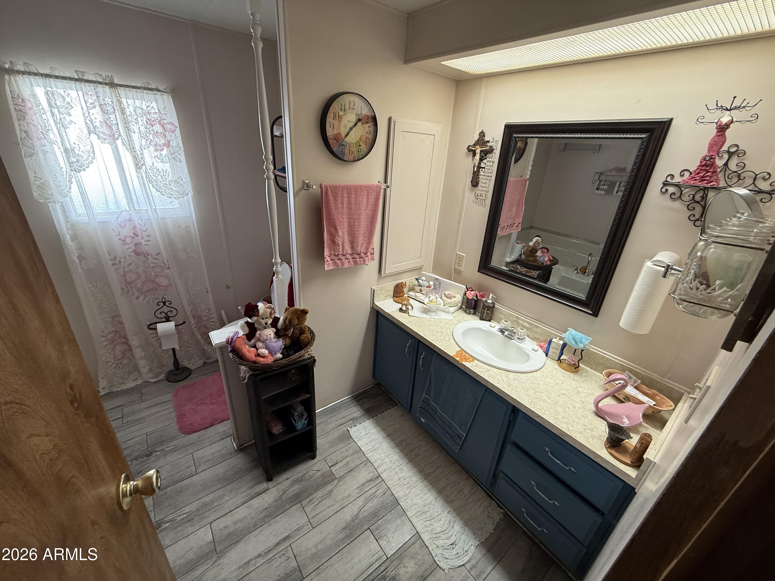9501 East Broadway Road, Unit 252 Mesa, AZ 85208 - Photo 30 of 31 a living room with furniture and a mirror
