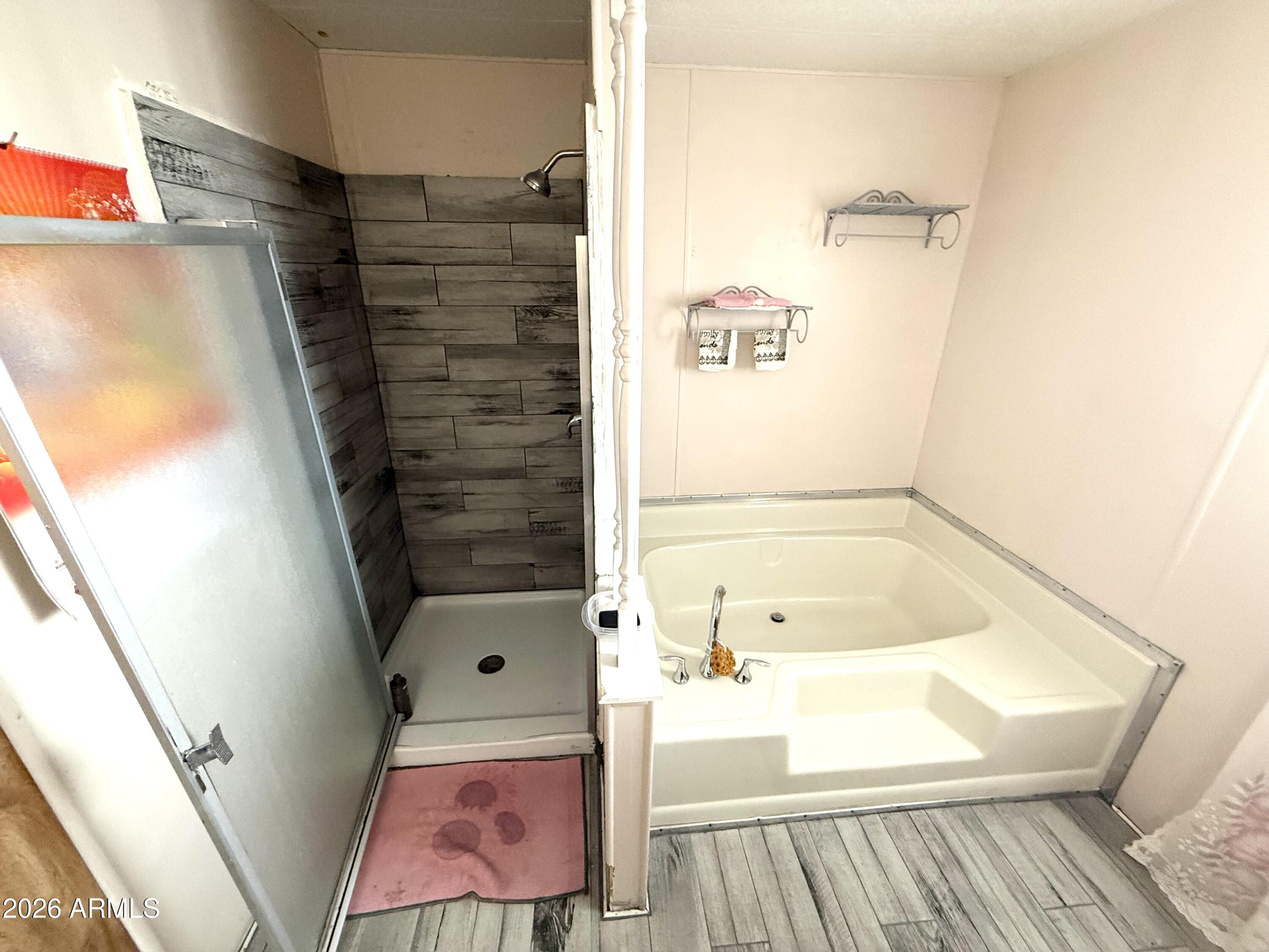 9501 East Broadway Road, Unit 252 Mesa, AZ 85208 - Photo 5 of 31 a bathroom with a bathtub and shower