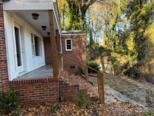 a view of house with a tree