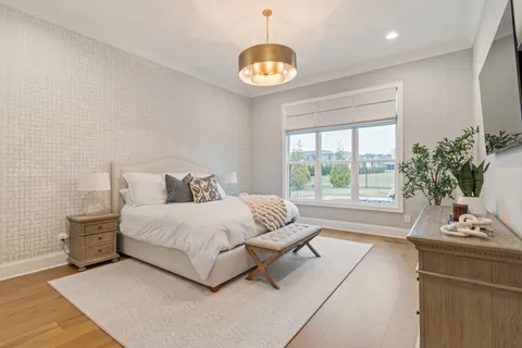 a spacious bedroom with a bed and a large window