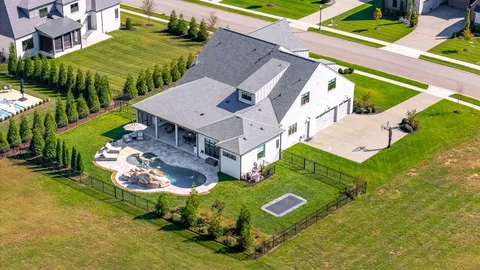 an aerial view of a house with a garden and swimming pool