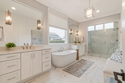 a bath room with a sink mirror and a bath tub
