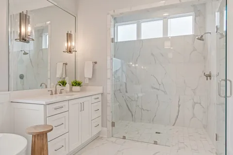 a bathroom with a sink a toilet and shower