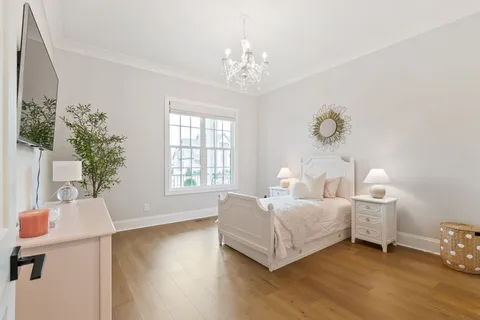 a bed room with a bed and a chandelier