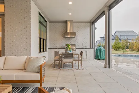 a dining room with furniture and a potted plant