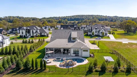 an aerial view of a house with a swimming pool