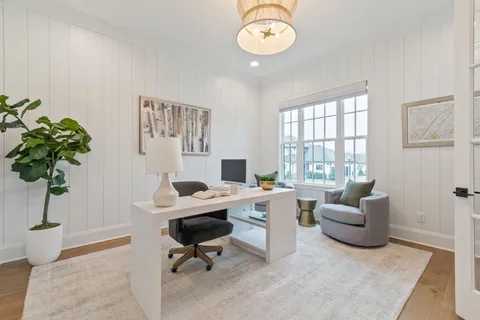 a view of a livingroom with workspace and a couch
