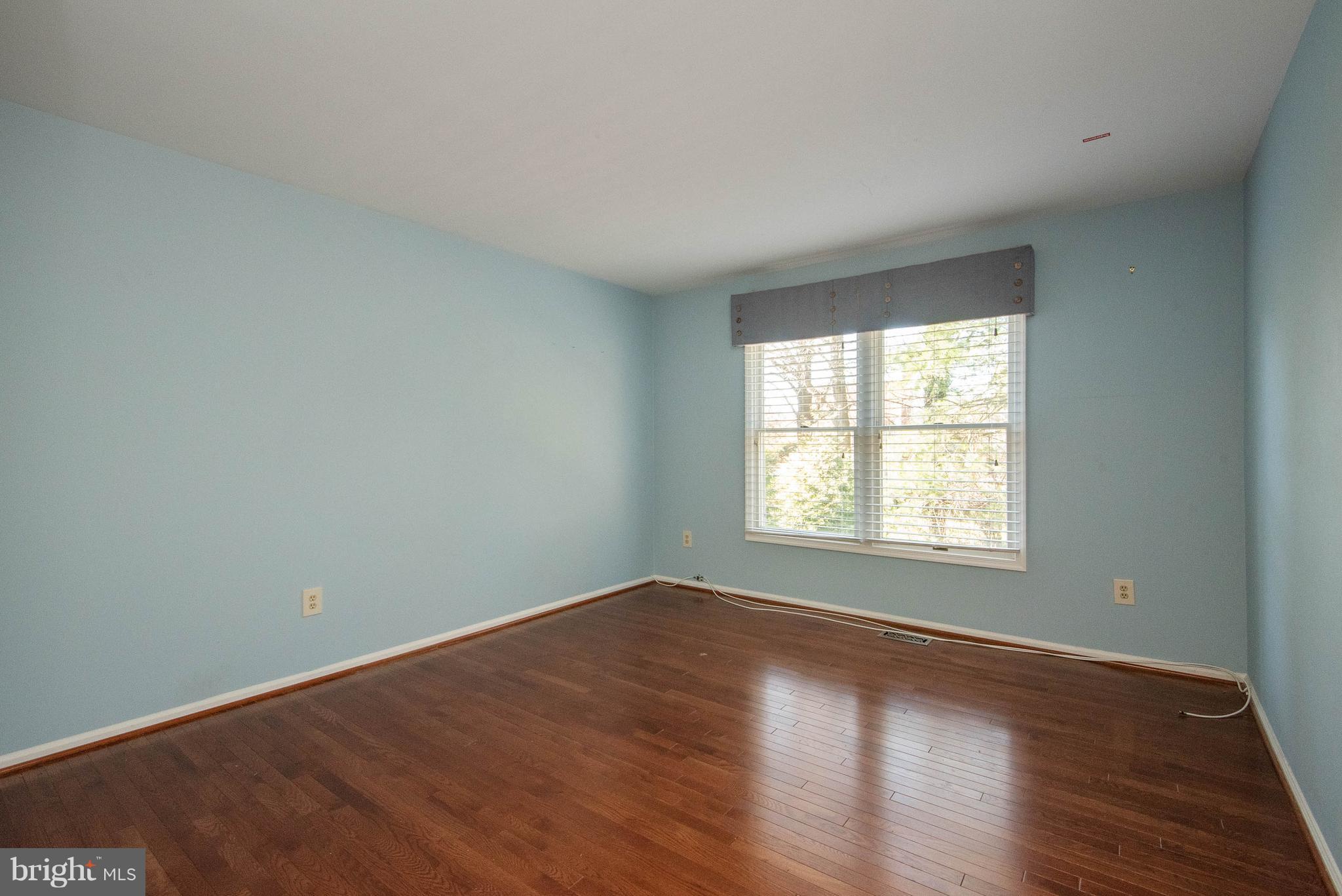 313 Canterfield Road Annapolis, MD 21403 - Photo 32 of 42 an empty room with wooden floor and windows