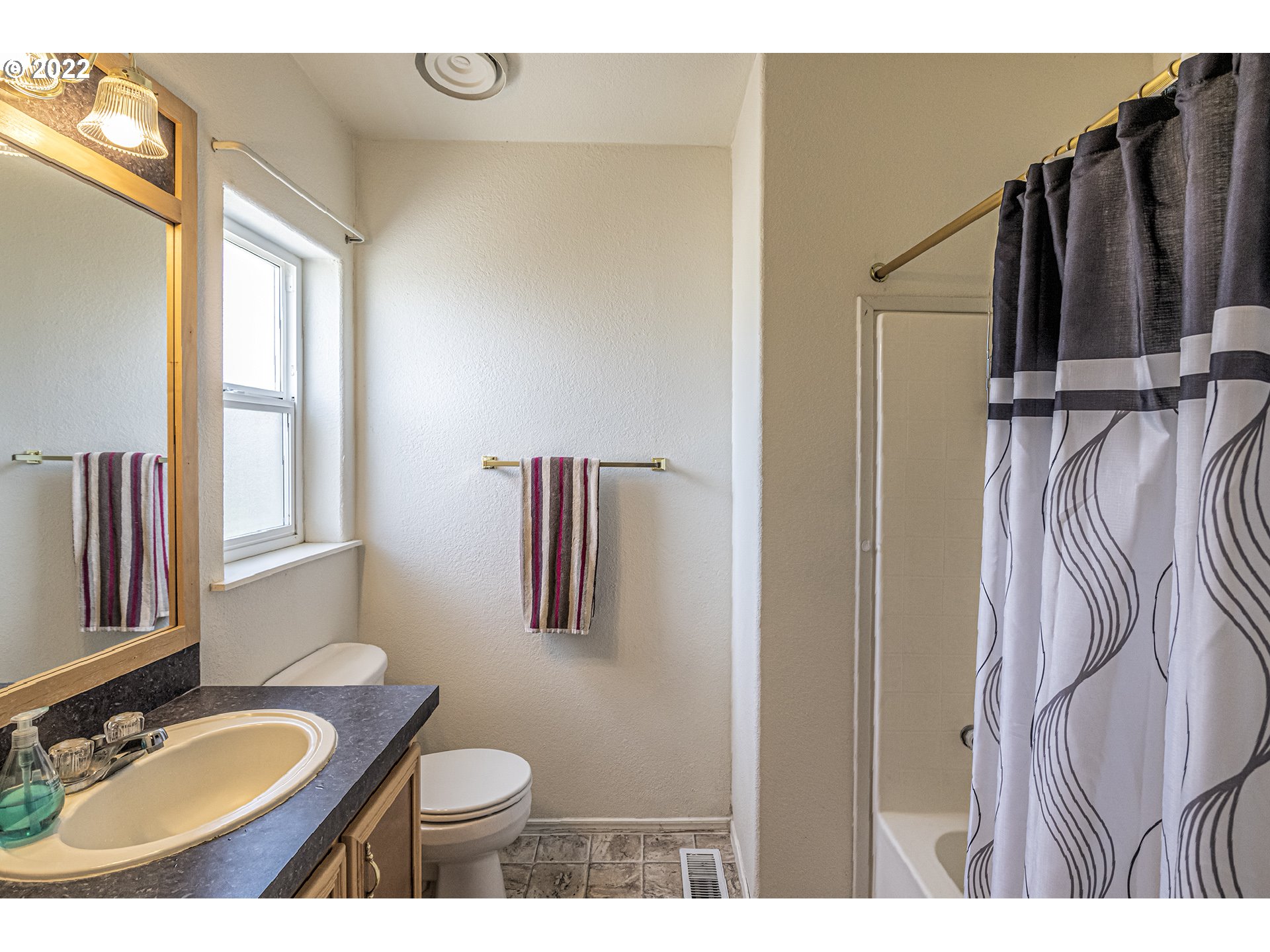 83007 County 643 Road Milton Freewater, OR 97862 - Photo 6 of 22 a bathroom with a granite countertop sink toilet and shower