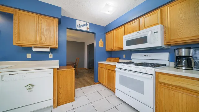 a dining room with furniture and a kitchen view