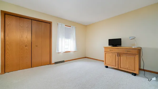 a view of an empty room with furniture and natural light