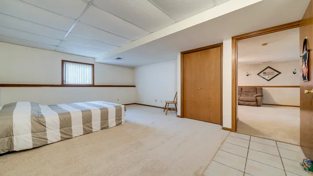 a spacious bedroom with a bed and a cabinets