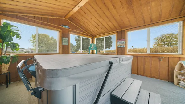 a view of a house with backyard porch and sitting area