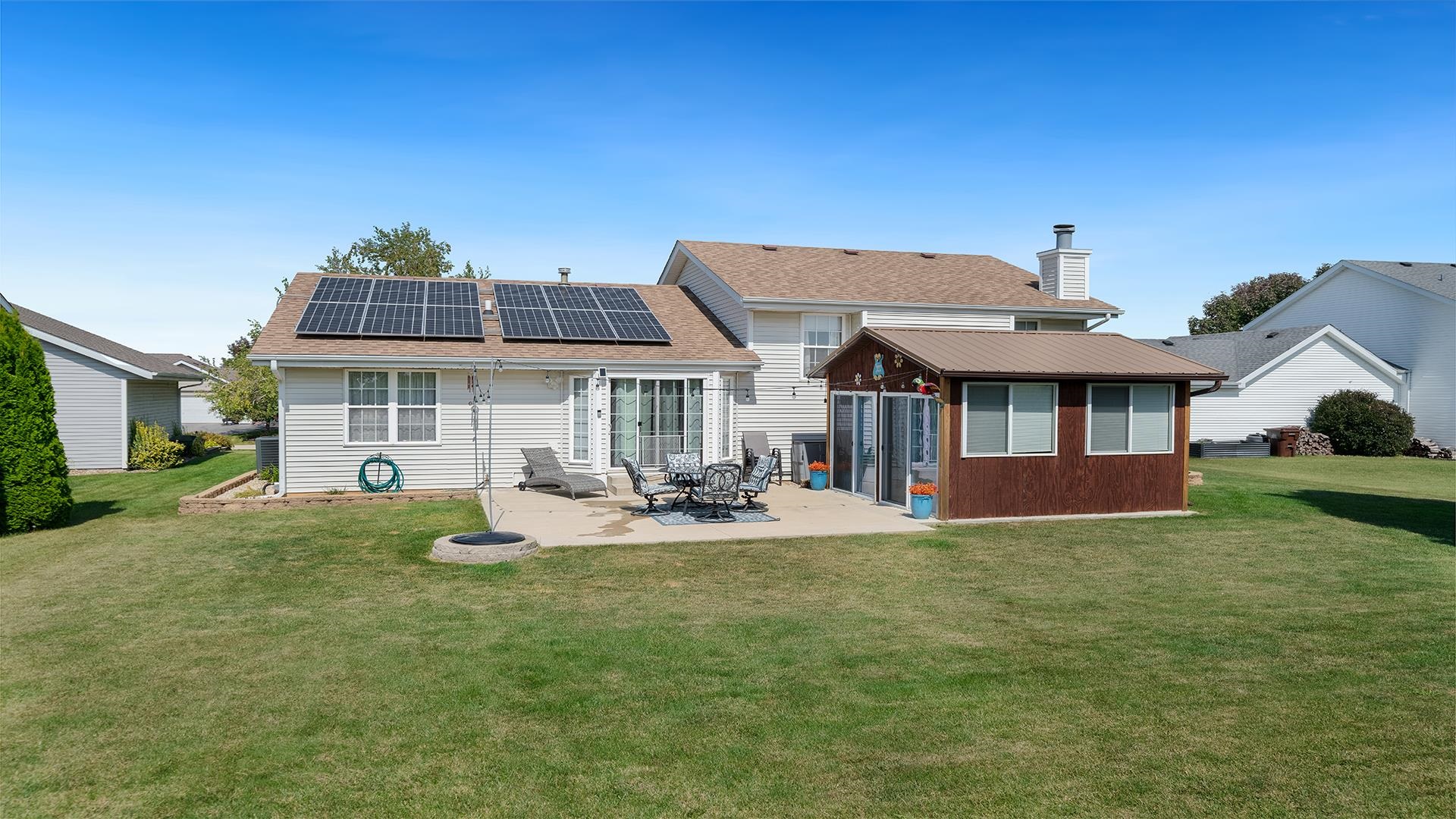 13116 Springhill Drive Winnebago, IL 61088 - Photo 40 of 50 a view of a house with backyard porch and sitting area