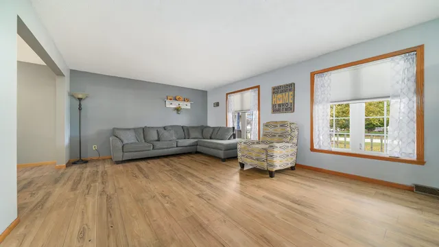 a living room with furniture and a wooden floor