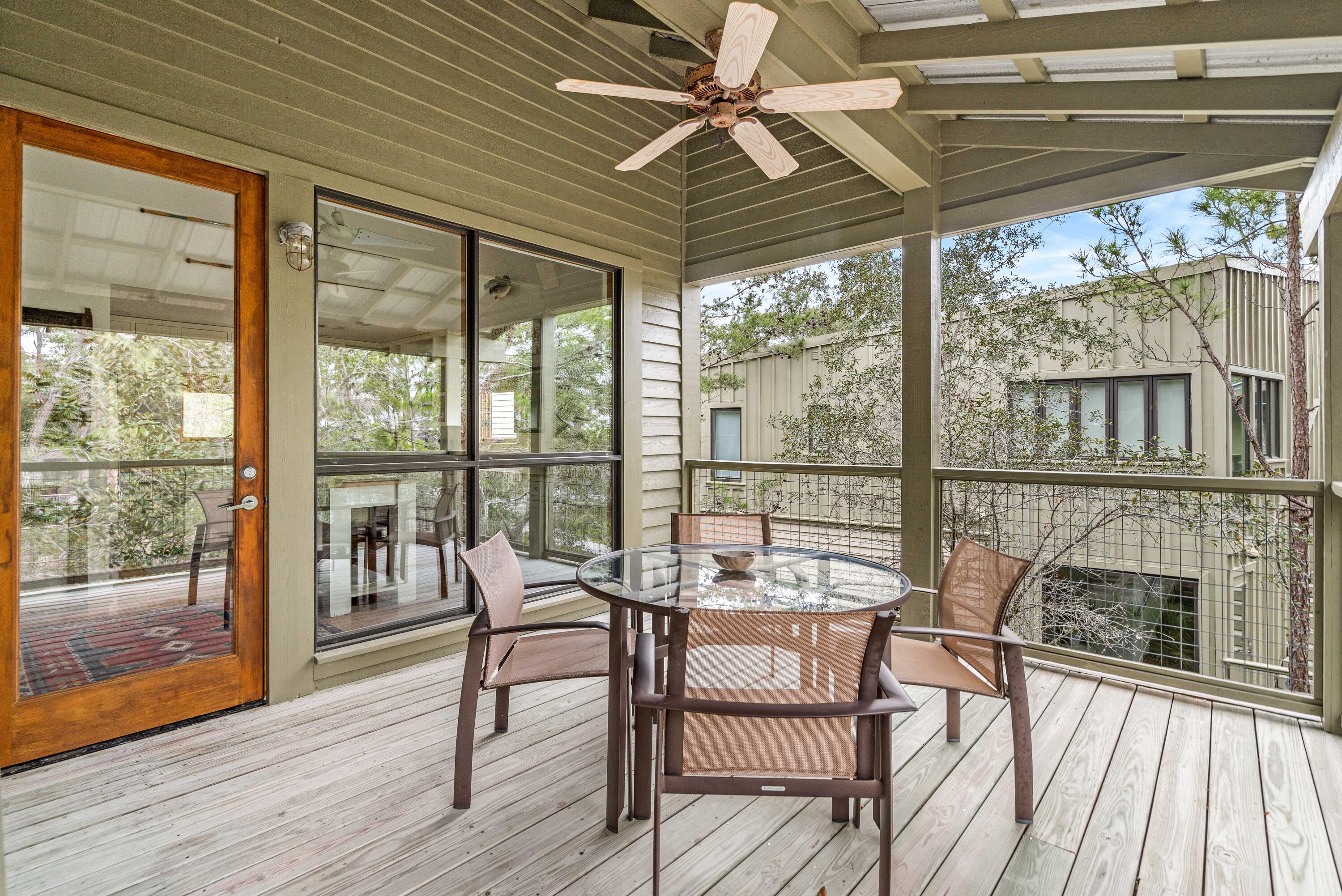 285 Wilderness Way Santa Rosa Beach, FL 32459 - Photo 39 of 69 a view of a dining room with furniture large windows and wooden floor