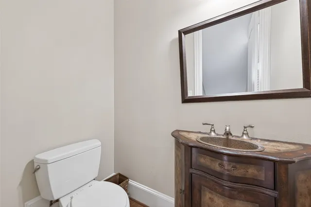 a view of a dining room and livingroom with furniture wooden floor a chandelier