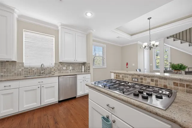 a view of entryway and dining room with wooden floor
