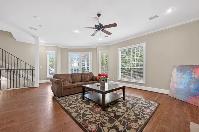a bedroom with a large bed chandelier and a window