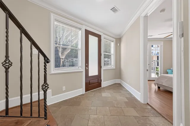 a bedroom with a bed window and a flat screen tv