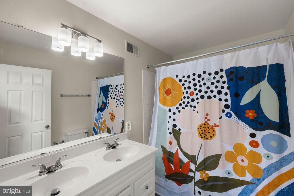 9823 Sherwood Farm Road Owings Mills, MD 21117 - Photo 13 of 29 a bathroom with a sink and mirror