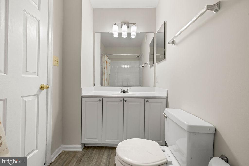 9823 Sherwood Farm Road Owings Mills, MD 21117 - Photo 20 of 29 a bathroom with a toilet a sink a vanity and mirror