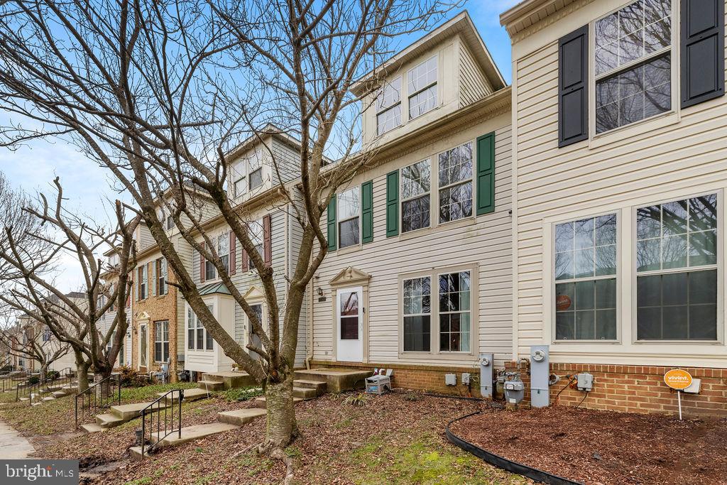9823 Sherwood Farm Road Owings Mills, MD 21117 - Photo 2 of 29 a front view of a house with a yard