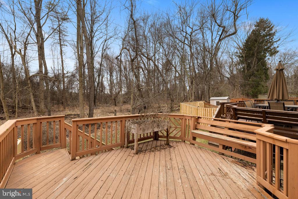 9823 Sherwood Farm Road Owings Mills, MD 21117 - Photo 28 of 29 a view of a roof deck with wooden floor and fence
