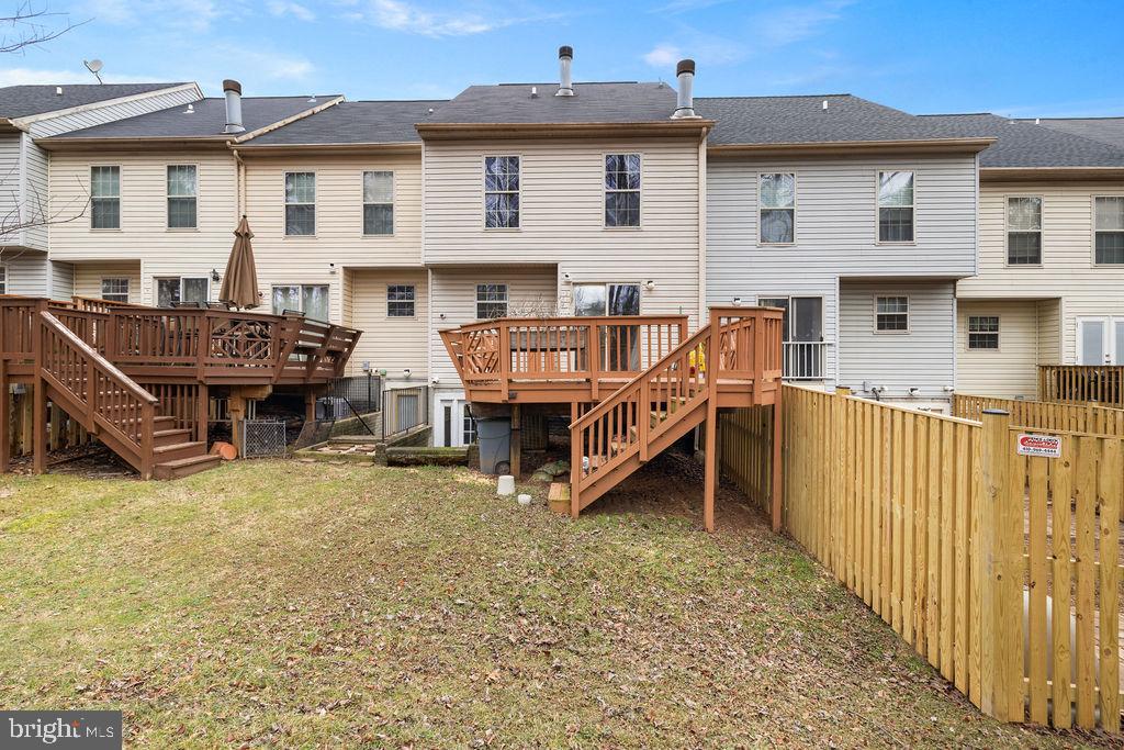 9823 Sherwood Farm Road Owings Mills, MD 21117 - Photo 29 of 29 a view of a house with wooden deck and furniture