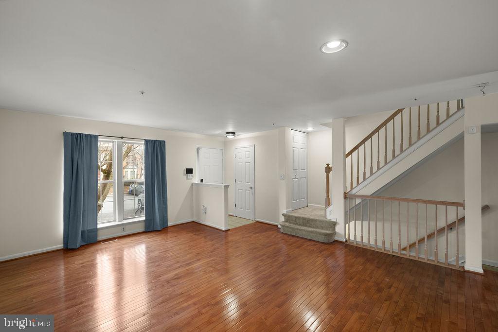 9823 Sherwood Farm Road Owings Mills, MD 21117 - Photo 5 of 29 a view of an empty room with wooden floor and stairs