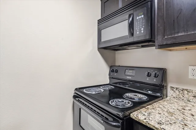 a stove top oven sitting inside of a kitchen